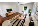 Bright living room featuring hardwood floors, natural light, a modern ceiling fan and a stylish accent rug at 3159 Nursery Se Rd, Smyrna, GA 30082