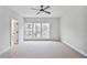 Spacious bedroom with neutral carpet, a ceiling fan, and plenty of natural light at 522 Pierce Nw Ave, Atlanta, GA 30318