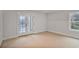 Light-filled room with soft carpet, a window, and doors leading to a balcony, perfect for relaxation at 522 Pierce Nw Ave, Atlanta, GA 30318