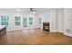 Bright living room with wood floors, a fireplace, and a kitchen view at 522 Pierce Nw Ave, Atlanta, GA 30318