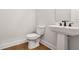 Half bathroom with a pedestal sink and modern fixtures at 522 Pierce Nw Ave, Atlanta, GA 30318