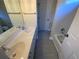 Modern bathroom featuring double sinks, a large mirror, and tile flooring leading to bathtub at 5055 Hickory Hills Dr, Woodstock, GA 30188
