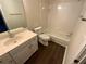 Cozy bathroom offers a tub, toilet, vanity with a sink and ample natural light from surrounding space at 5055 Hickory Hills Dr, Woodstock, GA 30188