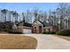 Attractive single-Gathering home with well-maintained landscaping, circular driveway, and two-car garage at 5055 Hickory Hills Dr, Woodstock, GA 30188