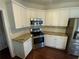 Updated kitchen features granite counters, stainless steel appliances, and modern white cabinetry at 5055 Hickory Hills Dr, Woodstock, GA 30188