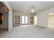 Spacious living room featuring built-in bookshelves and french doors at 5055 Hickory Hills Dr, Woodstock, GA 30188