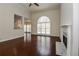 Open-concept living room with hardwood floors, fireplace, and views into the kitchen area at 5055 Hickory Hills Dr, Woodstock, GA 30188