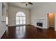 Spacious living room featuring hardwood floors, a fireplace, and a large window at 5055 Hickory Hills Dr, Woodstock, GA 30188