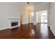 An open concept living room with hardwood floors, a fireplace, and abundant natural light at 5055 Hickory Hills Dr, Woodstock, GA 30188