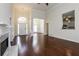 Large living room featuring hardwood floors, a fireplace, and a view to the foyer and kitchen at 5055 Hickory Hills Dr, Woodstock, GA 30188