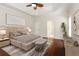 Spacious primary bedroom with tray ceilings, hardwood flooring, and modern decor at 5055 Hickory Hills Dr, Woodstock, GA 30188