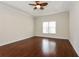 A primary bedroom featuring hardwood floors, neutral walls, and a window at 5055 Hickory Hills Dr, Woodstock, GA 30188