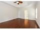 A primary bedroom featuring hardwood flooring and great natural light from a large window at 5055 Hickory Hills Dr, Woodstock, GA 30188