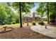Manicured backyard featuring a stone patio, landscaped garden beds, and lush greenery at 1655 Arrowhead Ne Trl, Atlanta, GA 30345