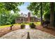 Expansive brick home with lush backyard, mature trees, and meticulously maintained lawn at 1655 Arrowhead Ne Trl, Atlanta, GA 30345