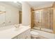 Bathroom featuring a shower with gold trim and a large vanity with ample counter space at 1655 Arrowhead Ne Trl, Atlanta, GA 30345