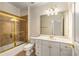 Bathroom with a glass-enclosed shower, large mirror, and neutral-colored tiles at 1655 Arrowhead Ne Trl, Atlanta, GA 30345