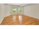 Bright bedroom with two large windows offering outside views and hardwood flooring throughout at 1655 Arrowhead Ne Trl, Atlanta, GA 30345