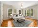Bright bedroom features hardwood floors, neutral walls, and large windows showcasing the outdoor greenery at 1655 Arrowhead Ne Trl, Atlanta, GA 30345