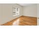 Bedroom filled with natural light from window with wood flooring and neutral wall color at 1655 Arrowhead Ne Trl, Atlanta, GA 30345