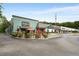 View of well landscaped exterior featuring multiple restaurants, outside seating and plenty of parking spaces at 1655 Arrowhead Ne Trl, Atlanta, GA 30345