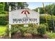 Briarcliff Woods Beach Club sign surrounded by manicured landscaping and lush greenery at 1655 Arrowhead Ne Trl, Atlanta, GA 30345