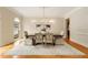 Elegant dining room featuring a chandelier, large window, and hardwood floors at 1655 Arrowhead Ne Trl, Atlanta, GA 30345