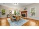 Charming dining area with a fireplace, wooden floors, and large windows offering plenty of natural light at 1655 Arrowhead Ne Trl, Atlanta, GA 30345