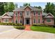 Classic brick home featuring symmetrical design, well-manicured landscaping, and elegant entrance at 1655 Arrowhead Ne Trl, Atlanta, GA 30345