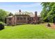 Spacious brick home with a large backyard, stone patio, and mature trees at 1655 Arrowhead Ne Trl, Atlanta, GA 30345