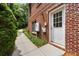 Exterior view of a brick home with a side entrance and landscaped walkway at 1655 Arrowhead Ne Trl, Atlanta, GA 30345