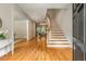 Grand foyer with hardwood floors, curved staircase, and views into the dining room at 1655 Arrowhead Ne Trl, Atlanta, GA 30345