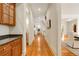 Long hallway with hardwood floors, storage, and access to multiple rooms at 1655 Arrowhead Ne Trl, Atlanta, GA 30345
