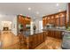 Open-concept kitchen featuring granite countertops, a large island, and custom cabinetry with stainless steel appliances at 1655 Arrowhead Ne Trl, Atlanta, GA 30345