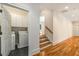 Bright laundry room with washer, dryer, tile floor, and white cabinets for storage in a well lit area at 1655 Arrowhead Ne Trl, Atlanta, GA 30345