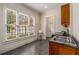 Spacious laundry room with stainless steel sink, granite counters and natural light at 1655 Arrowhead Ne Trl, Atlanta, GA 30345