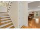 Bright stairway with hardwood steps, a window, a white door, and views into another room at 1655 Arrowhead Ne Trl, Atlanta, GA 30345