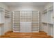 Walk-in closet featuring custom shelving, storage drawers, and hardwood floors at 1655 Arrowhead Ne Trl, Atlanta, GA 30345