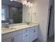 Modern bathroom vanity with double sinks and white cabinets, complemented by a glass enclosed shower at 1114 Low Water Crossing, Acworth, GA 30101