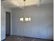 Bright dining room featuring wainscoting, a coffered ceiling, and a stylish chandelier at 1114 Low Water Crossing, Acworth, GA 30101