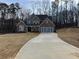 Spacious new home with a brick and stone facade, a three-car garage and a long driveway at 1114 Low Water Crossing, Acworth, GA 30101