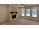Cozy living room with a brick fireplace and large windows offering a view of the outdoors at 1114 Low Water Crossing, Acworth, GA 30101