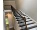 Elegant staircase featuring dark wood steps, white risers, and wrought iron spindles at 1114 Low Water Crossing, Acworth, GA 30101