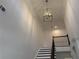 Dramatic two-story foyer with custom pendant lighting illuminating the staircase and landing at 1114 Low Water Crossing, Acworth, GA 30101