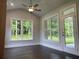 Bright sunroom with hardwood floors and large windows offering natural light and wooded views at 1114 Low Water Crossing, Acworth, GA 30101
