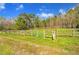 Serene pasture with wooden fence and gate, ready for horses at 450 Pat Rich Dr, Canton, GA 30115
