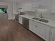 Modern kitchen featuring white cabinets, stainless steel appliances, and light countertops at 3510 Stonewall Se Pl, Atlanta, GA 30339