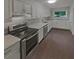 Modern kitchen featuring white cabinets, stainless steel appliances, and light countertops at 3510 Stonewall Se Pl, Atlanta, GA 30339