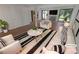 Bright living room with a fireplace and large windows complemented by modern furniture and decor at 3510 Stonewall Se Pl, Atlanta, GA 30339