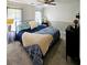 Bedroom featuring a blue bedspread, dark furniture and natural lighting at 57 Glenn Eagles Way, Hiram, GA 30141